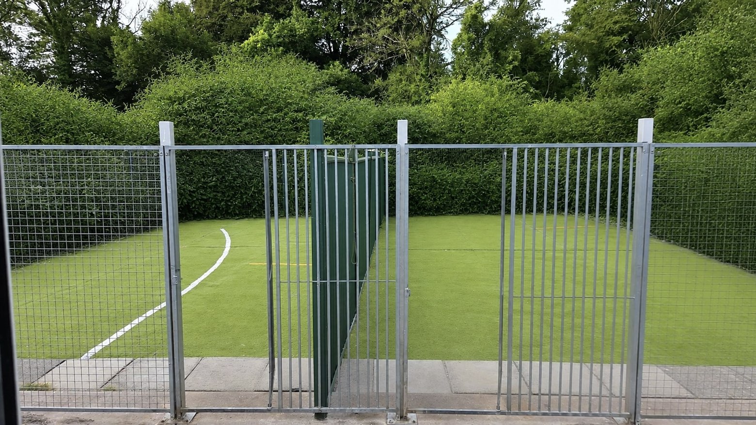 Secure fenced AstroTurf play area with hedged surround
